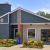 exterior of clubhouse with flower beds in front of it