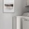 washer and dryer with shelves above it