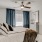 a bedroom with a bed and a fan