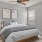 a bed in a room with side table and painting on the wall