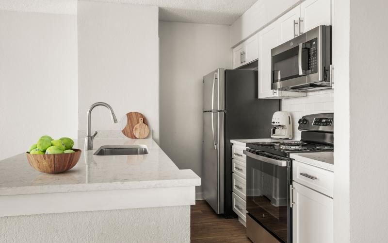 a kitchen with white cabinets