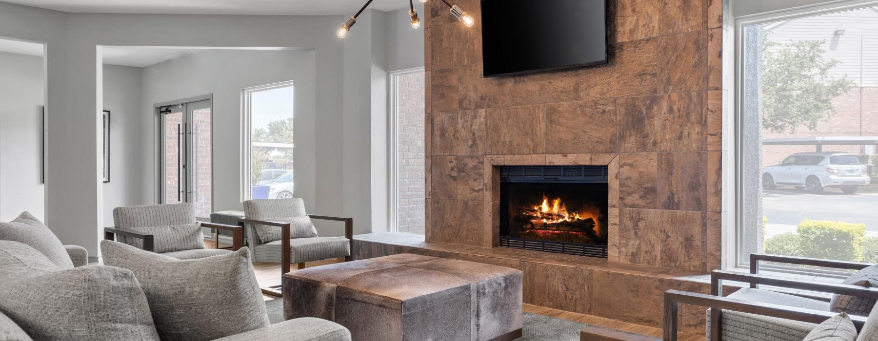 a club room with a fireplace